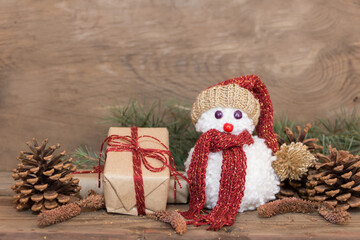 snowmen made with wool pompoms, on a Christmas background