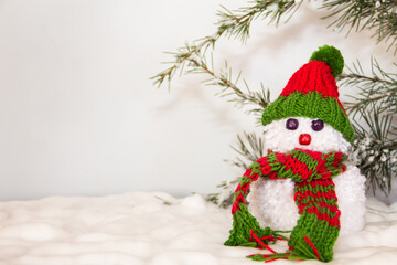 snowmen made with wool pompoms, on a Christmas background