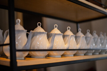 white porcelain tea pot on the shelf.