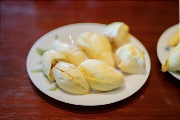 Durian in white plate  on wood table.