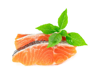 Piece of fresh salmon fillet sliced with leaf basil isolated on white background