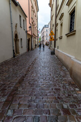Fototapeta na wymiar Cobblestone roads are a feature in Krakow and the Main Market Square.