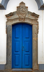 Fototapeta na wymiar Baroque blue door at historical city of Congonhas do Campo, Minas Gerais, Brazil