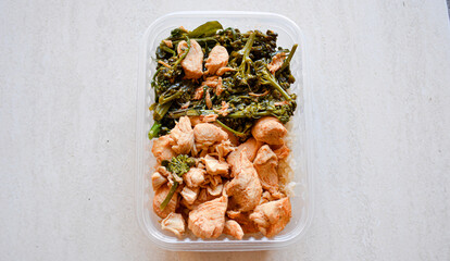 healthy lunch box with grilled chicken and broccoli