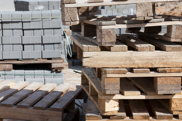 empty wooden pallets and new construction tiles