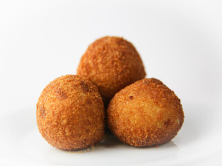 Potato balls on white plate close up