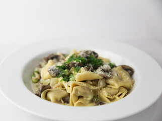 Tortellini with cream, peas and mushrooms