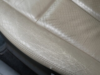 closeup of old brown leather car seat texture.
