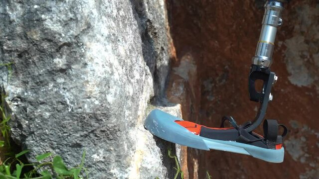 man with prosthesis rock climbing