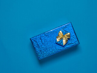 Top view of two bright gift boxes on a blue background.