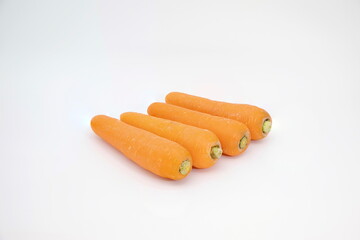 Carrots placed in a row on a white background.