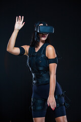 A young woman in a virtual reality suit that allows her whole body to plunge into VR. EMS.