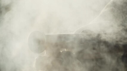 Old medieval handgun extreme closeup, wick and torch set fire of gunpowder, front view shooting slow motion