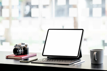 Mockup blank screen laptop computer on wooden counter table in co-workspace.