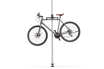 Gray bicycle for repair hanging on a stand