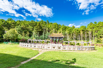 A meadow and pavilion at the entrance of Weibao Mountain, Dali, Yunnan, China