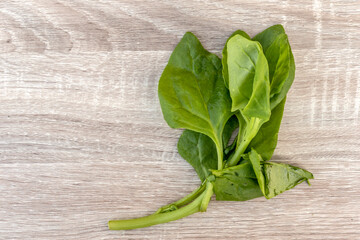 spinach leaves (Spinacia oleracea) on the wooden table in Brazil