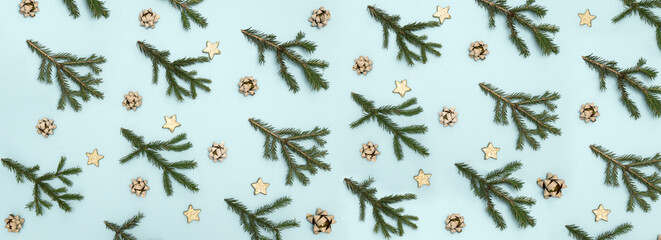Christmas abstract fashion background layout with fir branches and Christmas toys. Sky blue background. Flat Lay. long banner