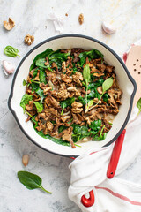 Homemade fried mushrooms with garlic and spinach