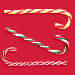 Fototapeta premium candy canes lollipops christmas on a red background