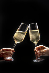 Couple celebrating with champagne on dark background