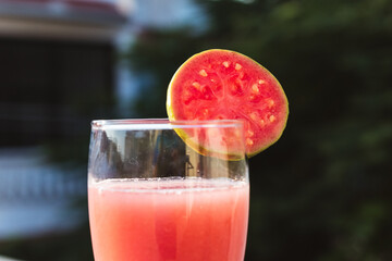 Close up shot of glass of organic Guava juice with fresh guava