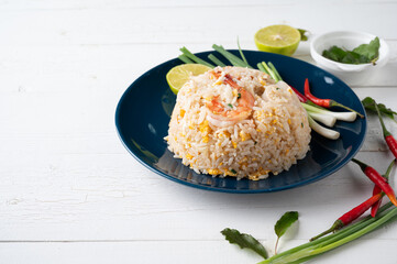 Fried rice with shrimp  and squid on the blue  dish on wooden table