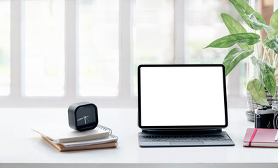 Mockup blank tablet with keyboard on white top table in living room.