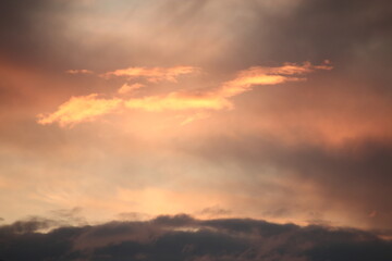 Fototapeta premium Clouds, in the rays of the setting sun.