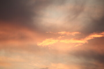 Naklejka na ściany i meble Clouds, in the rays of the setting sun.