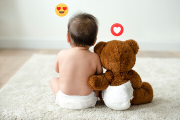 Toddler sitting beside his teddy bear - obrazy, fototapety, plakaty