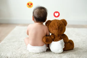 Fototapeten Toddler sitting beside his teddy bear © Rawpixel.com
