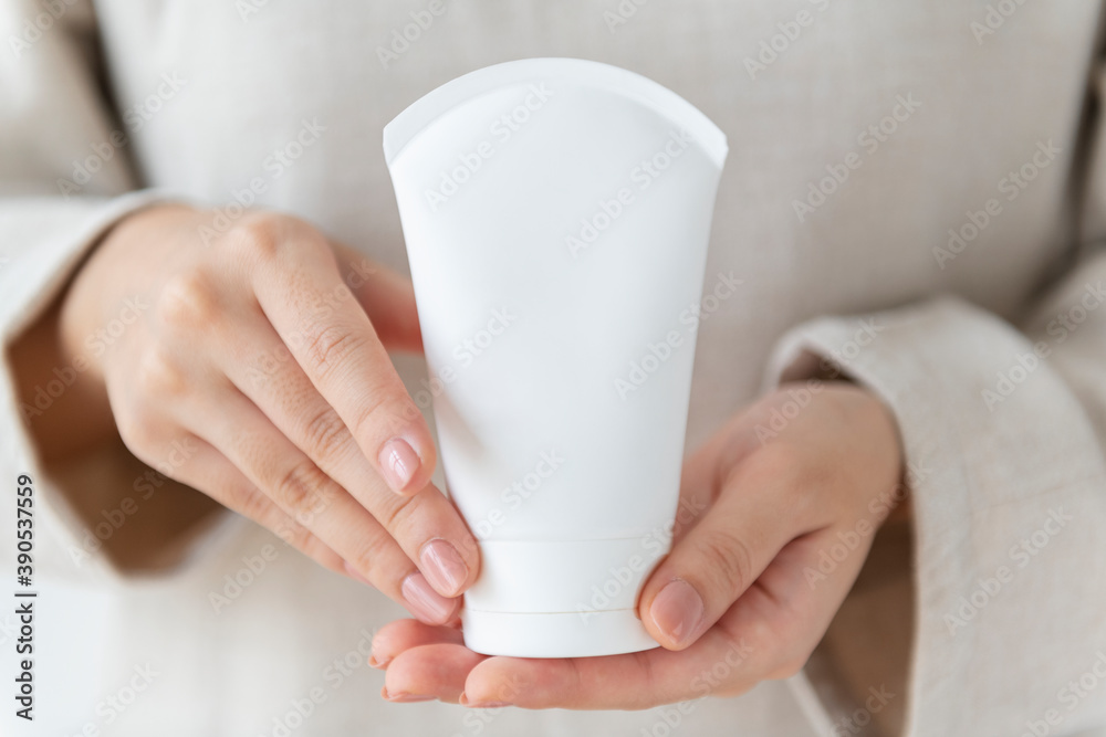 Poster woman holding a facial cream tube