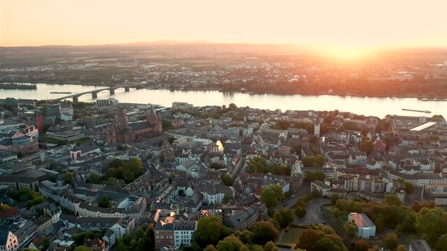 Mainz in best morning light with an aerial drone view showing the city center old town and the Theodor-Heuss-Brdige with the Rhine river in the back in Germany