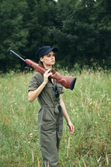 Military woman gun on shoulder hunting lifestyle green leaves 