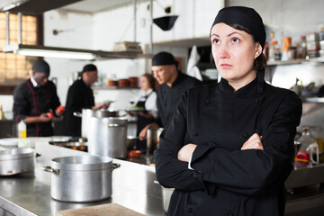Upset female cook in kitchen of restaurant. High quality photo