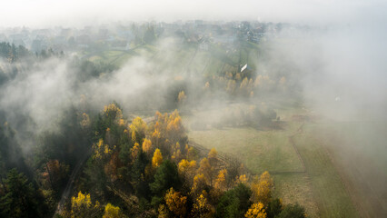 Fototapeta premium Mountain village in a early moorning with fog and autumn leaves