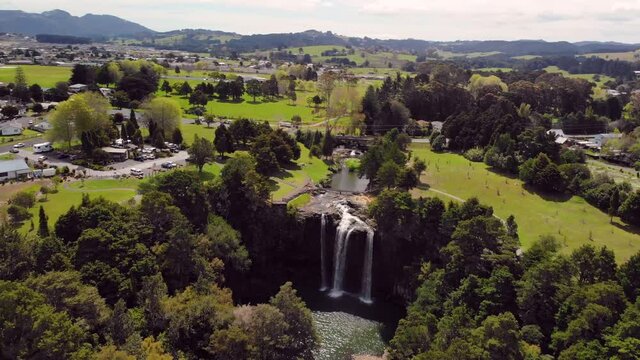 Beautiful waterfall in city park aerial orbit shot.  Whangarei Falls, Northland. Landscape of New Zealand.