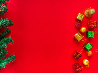 Fototapeta na wymiar Christmas tree decorations, gift boxes, ball drop.On a red background To beautify the Christmas tree