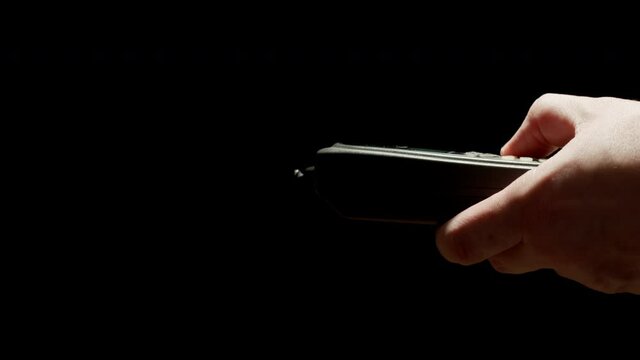 Man using old mobile phone. Outdated push button cellphone. Close up.