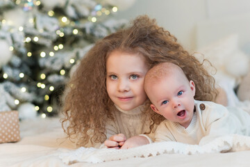 Chidren christmas morning. Merry Christmas and Happy Holidays. Cheerful cute childrens having fun near tree. Loving family with presents in room. Christmas eve at home