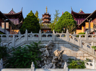 Architecture complex in ancient Jiming (Rooster Crowing) Temple with stone steps & handrail, wing halls, Bell & Drum Towers, Vairocana Hall, Medicine Buddha Pagoda in Nanjing, Jiangsu, China.