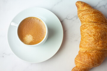 two cups of coffee and croissants.