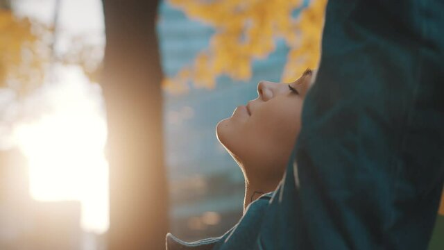 beutiful young woman with short blond hair waving rainbow flag in the park. High quality 4k footage