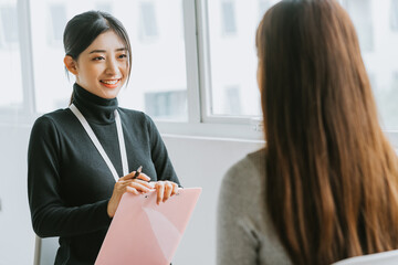 The recruitment officer is interviewing the candidate
