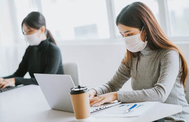 Two women have to wear masks during working hours to stay safe during epidemics
