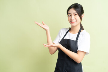 a Asian woman pointing up

