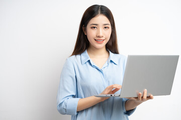 Asian woman holding a laptop in her hand
