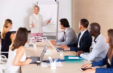 Business woman making presentation on staff meeting at office