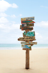 View of wooden signpost on summer tropic beach 
